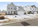 Two-story house with gray siding, a white garage door, and a snow-covered lawn at 803 Golden Plum Ln, Zebulon, NC 27597