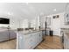 Open concept kitchen with island, granite countertops, and stainless steel appliances at 803 Golden Plum Ln, Zebulon, NC 27597