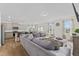 Open concept living room with sectional sofa and adjacent kitchen at 803 Golden Plum Ln, Zebulon, NC 27597