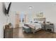 Bright bedroom with large bed, wood nightstand, and teal bench at 803 Golden Plum Ln, Zebulon, NC 27597