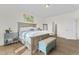 Spacious main bedroom with large bed, wood nightstands, and teal bench at 803 Golden Plum Ln, Zebulon, NC 27597