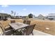 Patio with table and chairs overlooking backyard at 803 Golden Plum Ln, Zebulon, NC 27597
