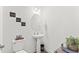 Convenient powder room with pedestal sink and decorative accents at 803 Golden Plum Ln, Zebulon, NC 27597