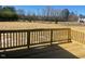 View of the wooden back porch and yard beyond the railing at 85 N Stagecoach Dr, Wendell, NC 27591