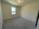 Cozy carpeted bedroom with a natural light-filled window at 85 N Stagecoach Dr, Wendell, NC 27591