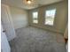 Spacious bedroom with two windows and plush carpeting at 85 N Stagecoach Dr, Wendell, NC 27591