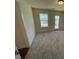 Spacious bonus room features neutral carpeting, window, and door to outdoor space at 85 N Stagecoach Dr, Wendell, NC 27591