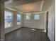 Spacious dining room featuring hardwood floors, decorative trim, a modern light fixture, and three windows at 85 N Stagecoach Dr, Wendell, NC 27591