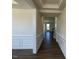 Entryway features decorative molding, dark hardwood flooring and a partial view of the staircase at 85 N Stagecoach Dr, Wendell, NC 27591