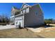 The side and rear exterior view of the home showing the driveway leading to the two-car garage at 85 N Stagecoach Dr, Wendell, NC 27591