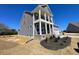 A side view of the exterior showing off the yard space and front entrance with a covered porch at 85 N Stagecoach Dr, Wendell, NC 27591