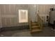 Garage with stairs and entrance to a storage area at 85 N Stagecoach Dr, Wendell, NC 27591