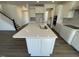 Bright kitchen featuring a white quartz countertop island with a stainless steel sink and modern faucet at 85 N Stagecoach Dr, Wendell, NC 27591