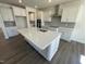 Bright kitchen features white cabinets, a large kitchen island with quartz countertops and stainless steel appliances at 85 N Stagecoach Dr, Wendell, NC 27591