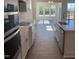 Kitchen features white cabinets, stainless steel appliances and a large window for natural light at 85 N Stagecoach Dr, Wendell, NC 27591
