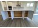 Kitchen island with white cabinets, storage, and hardwood flooring at 85 N Stagecoach Dr, Wendell, NC 27591