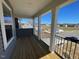 Open porch with stately columns, dark railings, and beautiful neighborhood views at 85 N Stagecoach Dr, Wendell, NC 27591