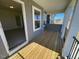 Covered porch with wood flooring and view of the yard at 85 N Stagecoach Dr, Wendell, NC 27591