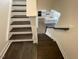 Staircase with wood treads and white risers leading to an open-concept kitchen at 85 N Stagecoach Dr, Wendell, NC 27591