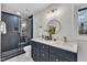 Modern bathroom with dark vanity, quartz countertops, and walk-in shower at 919 Fiske St, Durham, NC 27703