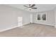Spacious bedroom with neutral carpeting and large window at 919 Fiske St, Durham, NC 27703