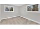 Spacious bedroom with neutral walls, carpet flooring, and two windows at 919 Fiske St, Durham, NC 27703