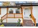 Inviting front porch with wood railing and brick steps at 919 Fiske St, Durham, NC 27703