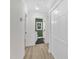 Clean hallway with light wood flooring, access to bathroom and closets at 919 Fiske St, Durham, NC 27703