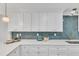 Modern kitchen with white cabinets, quartz countertops and gold accents at 919 Fiske St, Durham, NC 27703