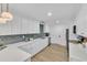 Updated kitchen with white cabinets, quartz countertops, and new appliances at 919 Fiske St, Durham, NC 27703