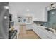 Modern kitchen with white cabinets, quartz countertops, and hexagon backsplash at 919 Fiske St, Durham, NC 27703