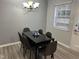 Bright dining area with glass table and six gray chairs at 1002 Willow Dr # Apt 54, Chapel Hill, NC 27514