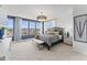 Large bedroom with natural light, featuring dark bed frame, and nightstands with lamps at 101 Ailey Brook Way # 100, Wake Forest, NC 27587