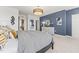 Tastefully decorated bedroom featuring a patterned bedspread, dresser and a stylish blue accent wall at 101 Ailey Brook Way # 100, Wake Forest, NC 27587
