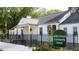 Exterior shot of the Wake Forest Community House with a black metal fence and blooming flowers in the front at 101 Ailey Brook Way # 100, Wake Forest, NC 27587