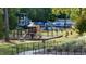View of a vibrant community playground with slides, climbing structures, and shaded picnic areas at 101 Ailey Brook Way # 100, Wake Forest, NC 27587