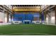 Wide indoor soccer field with artificial turf, surrounded by sports branding and metal beams at 101 Ailey Brook Way # 100, Wake Forest, NC 27587