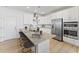 Modern kitchen island with granite countertops, stainless steel appliances, and seating for casual dining at 101 Ailey Brook Way # 100, Wake Forest, NC 27587