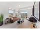 Cozy living room with neutral carpet, brown sofa, natural lighting, and balcony access at 101 Ailey Brook Way # 100, Wake Forest, NC 27587