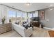 Bright living room with large windows, white sofas, hardwood floors, and tasteful decor at 101 Ailey Brook Way # 100, Wake Forest, NC 27587