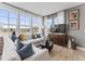 Bright and airy living room featuring large windows, plush seating, and contemporary furnishings at 101 Ailey Brook Way # 100, Wake Forest, NC 27587