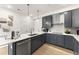 Contemporary kitchen with sleek gray cabinets, stainless steel appliances, and bright lighting at 105 Ailey Brook Way # 100, Wake Forest, NC 27587