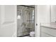 Bathroom with a walk-in shower and marble tile at 1064 Jersey St, Haw River, NC 27258