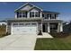 Charming two-story home featuring stone accents, a two-car garage, and a well-maintained lawn at 107 Northwood Dr, Fuquay Varina, NC 27526