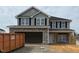 Charming two-story home featuring a stone facade, gray siding, and a spacious two-car garage at 107 Northwood Dr, Fuquay Varina, NC 27526