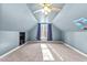 Sloped ceiling bedroom featuring carpeted floors, neutral walls, and a ceiling fan at 108 Doe Cir, Selma, NC 27576