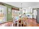 Charming eat-in kitchen features wood floors, white cabinetry, and a bright, airy feel at 108 Doe Cir, Selma, NC 27576