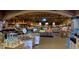 Grocery store interior featuring fresh produce displays, wine selections, and shoppers browsing under bright lights at 109 Ailey Brook Way # 100, Wake Forest, NC 27587