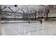 Large, well-lit ice rink with players skating, featuring branded dasher boards and high ceilings at 109 Ailey Brook Way # 100, Wake Forest, NC 27587