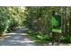 Scenic nature trail surrounded by lush greenery and trees with sign displaying regulations at 109 Ailey Brook Way # 100, Wake Forest, NC 27587